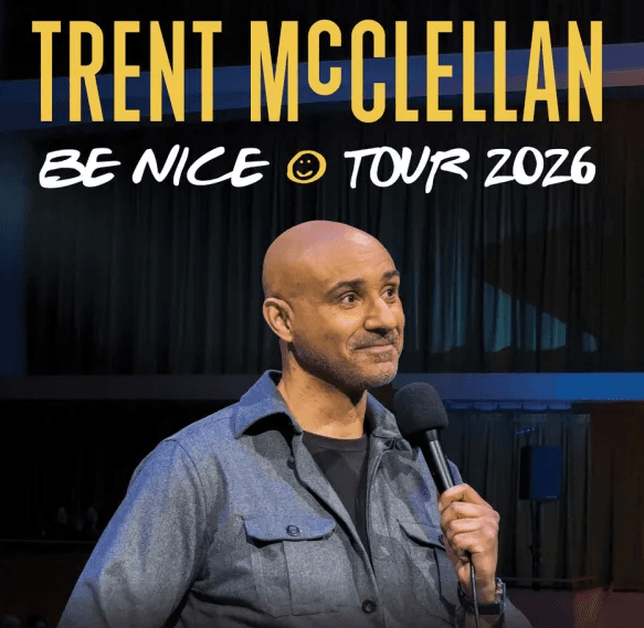 Poster shows a bald man holding a microphone on stage, wearing a gray button-up shirt. Text reads “Trent McClellan” and “Be Nice ☺ Tour 2026.” Dark curtain background with stage lighting.